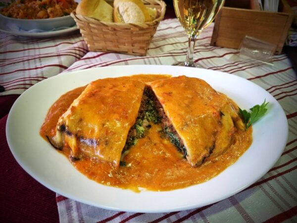 Lasaña rellena de carne, verdura, jamón y muzzarella con salsa rosa