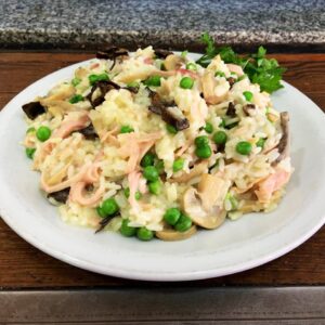 Arroz cremoso con jamón, hongos secos, champiñones y arvejas
