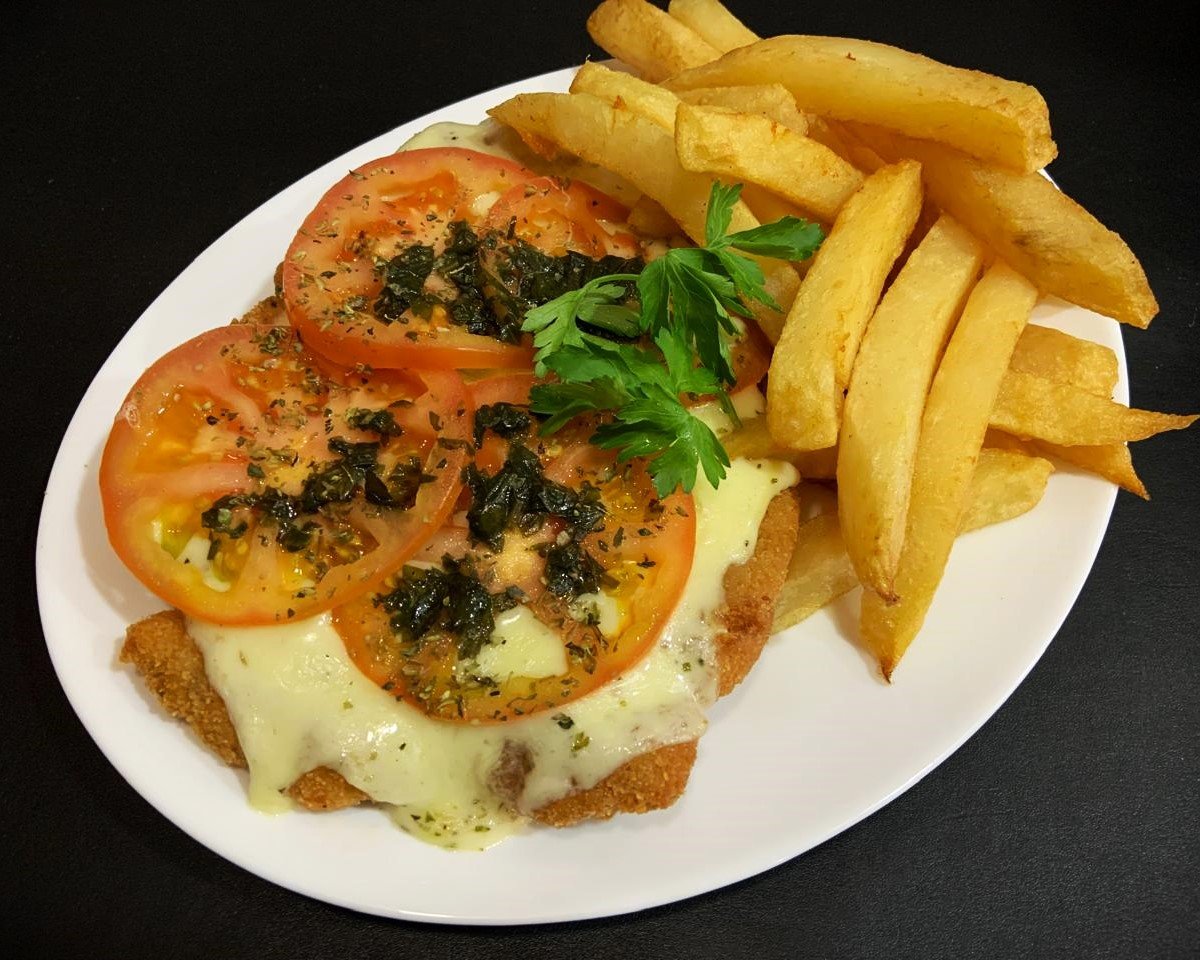 Milanesa de pollo caprese con papas fritas